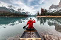 Male-traveler-in-winter-coat-canoeing-in-Spirit-Island-on-Maligne-Lake-at-Jasper-national-park-AB-Canada.jpg